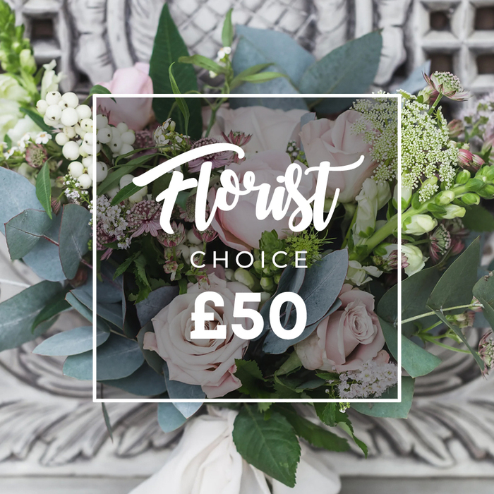 The central focus of this image is a lush, artfully assembled bouquet of blush-pink roses, white berries, and varied greenery, arranged with an assured, natural hand. The roses dominate with softly unfurling petals in pale pink that read romantic and refined; closely nestled among them are bright white berries-snowberry or hypericum-like clusters-that add punctuation and a lively, textural contrast. Dusty, rounded eucalyptus leaves thread cool, blue-green tones throughout the bouquet, their matte finish and scent grounding the florals. Tiny white filler flowers-perhaps waxflower or spray lisianthus-create a delicate lace-like veil around the larger blooms, while occasional deeper pink or burgundy sprigs add visual depth. Taller, slender spikes peek from the composition's edges, lending height and a relaxed, garden-picked profile.
The stems are bound with a soft cream fabric ribbon, visible at the base and suggesting a hand-tied finish, and the bouquet sits before a softly blurred background of ornate, light-coloured carved stone or plaster that implies an elegant setting. A clean white rectangular overlay frames the words Florist in a flowing script with CHOICE and the clear price £50 beneath, visually communicating the curated nature of the arrangement. The overall impression is of understated luxury and careful craft-an arrangement that would suit a milestone celebration, a thoughtful thank-you, or a welcoming gift for a new home in Canning Town, perhaps destined for a mantelpiece near Connaught Estate or a window ledge overlooking the Royal Docks.